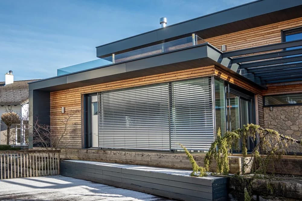 Modern home with dark timber-look exterior cladding installed by Elite Surface Group