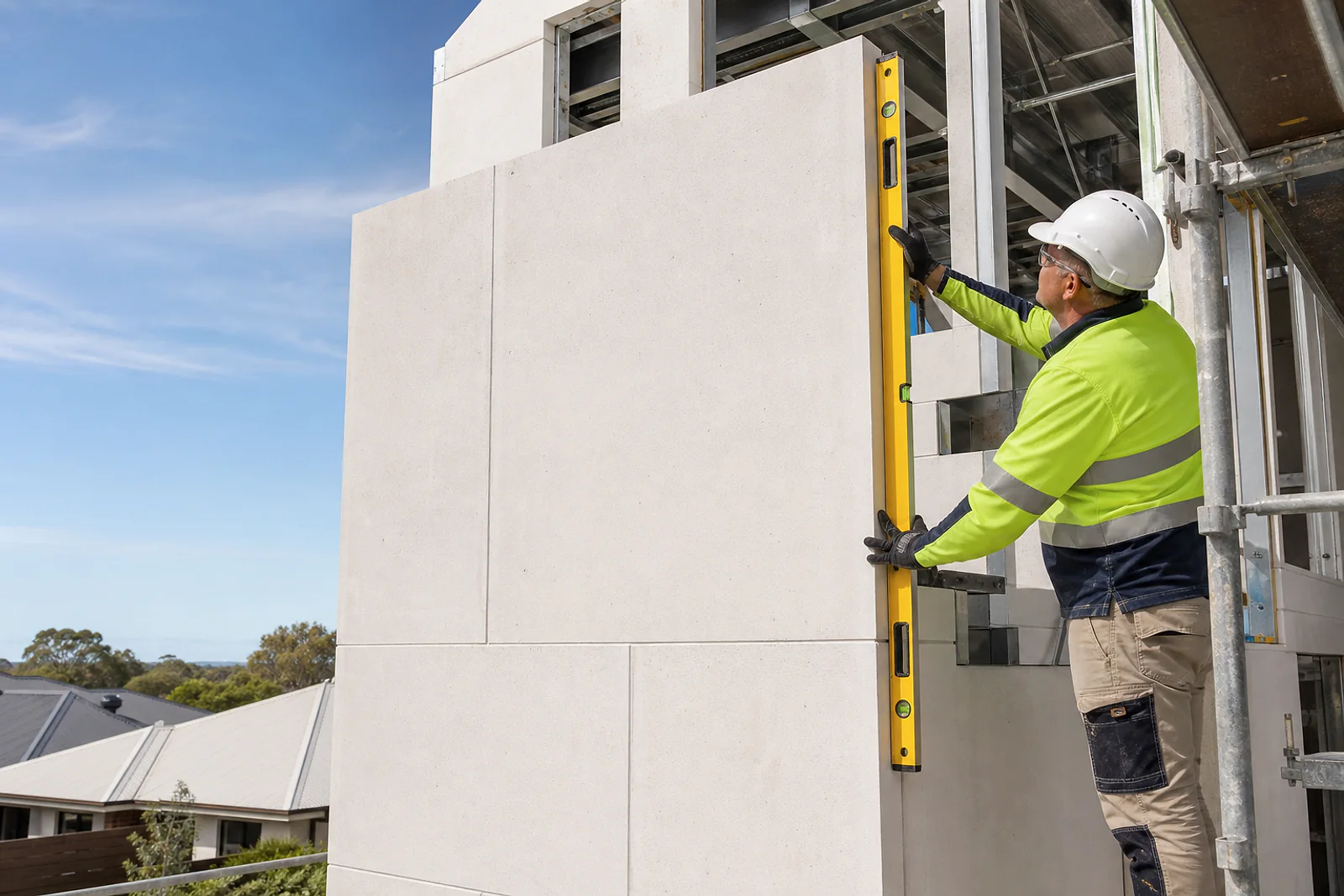 Installer checking lightweight AAC wall panels on a new build